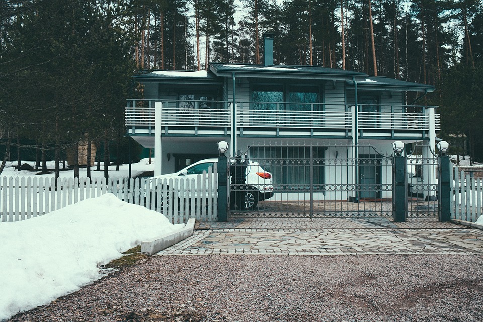 A modern home with a black electronic gate