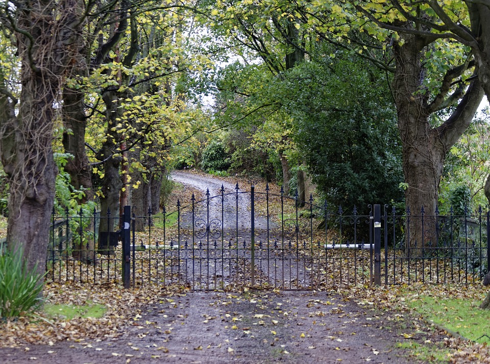 An automatic swing gate at the end of a country lane