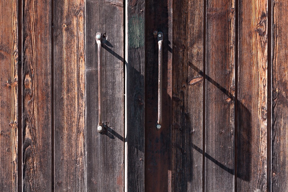 An old wooden gate with metal handles