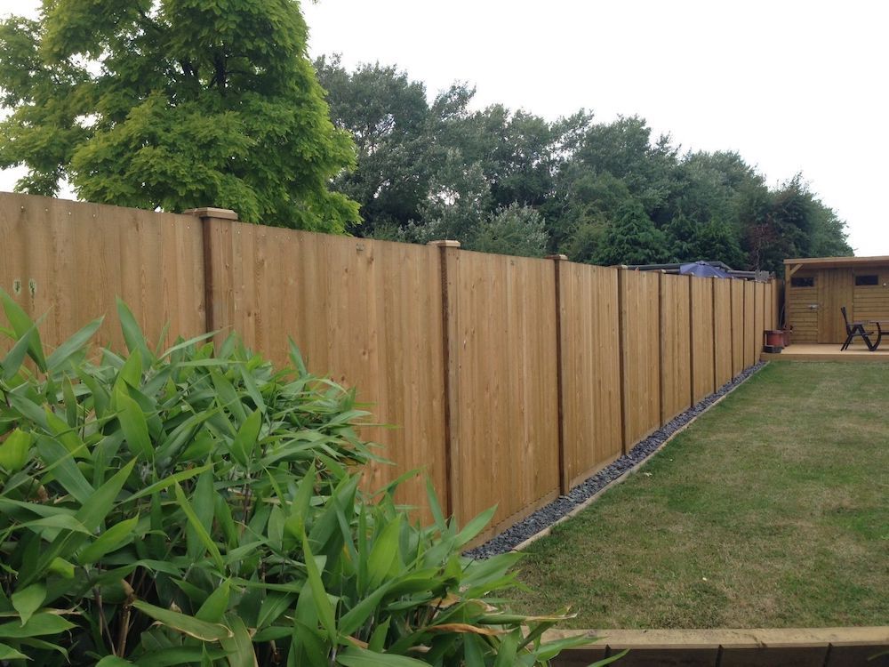 a wooden fence around the outside of a garden