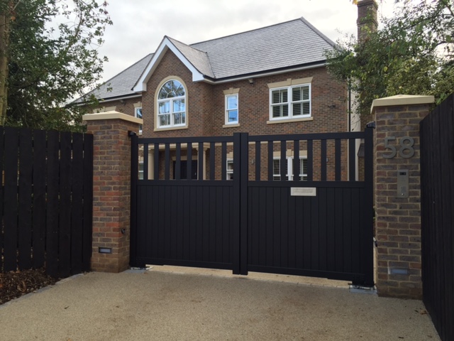 A picture of a house with an electric gate